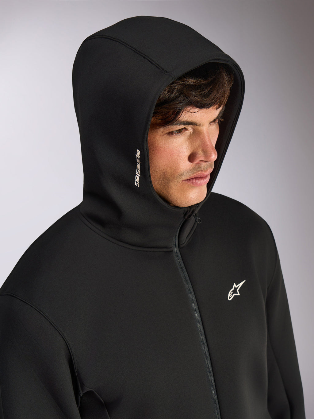 Alpinestars Cypher Hoodie, felpa nera con zip frontale e cappuccio a collo alto, logo Alpinestars bianco sul cappuccio e logo a stella sul petto, streetwear casual ispirato al motorsport