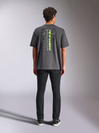 Alpinestars Overhang Oversized CSF Tee, t-shirt a maniche corte, grigio antracite, vista posteriore con logo Alpinestars verticale verde neon e testo grafico, vestibilità oversize, streetwear casual motorsport