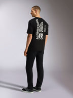 Alpinestars T-shirt One Oversized CSF, maglietta a maniche corte, nero, vista posteriore con grafica bianca verticale 'ALPINESTARS ONE GOAL. ONE VISION.', vestibilità oversize, streetwear casual ispirato al motorsport
