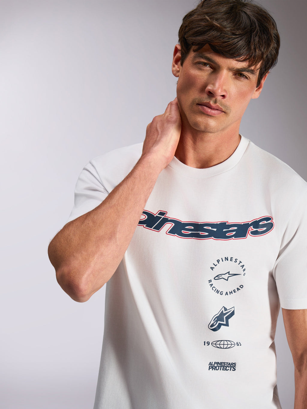 Alpinestars Abus CSF Tee, t-shirt a maniche corte, bianca, con logo Alpinestars curvo blu navy con contorno rosso e grafiche multiple impilate, abbigliamento casual motorsport streetwear