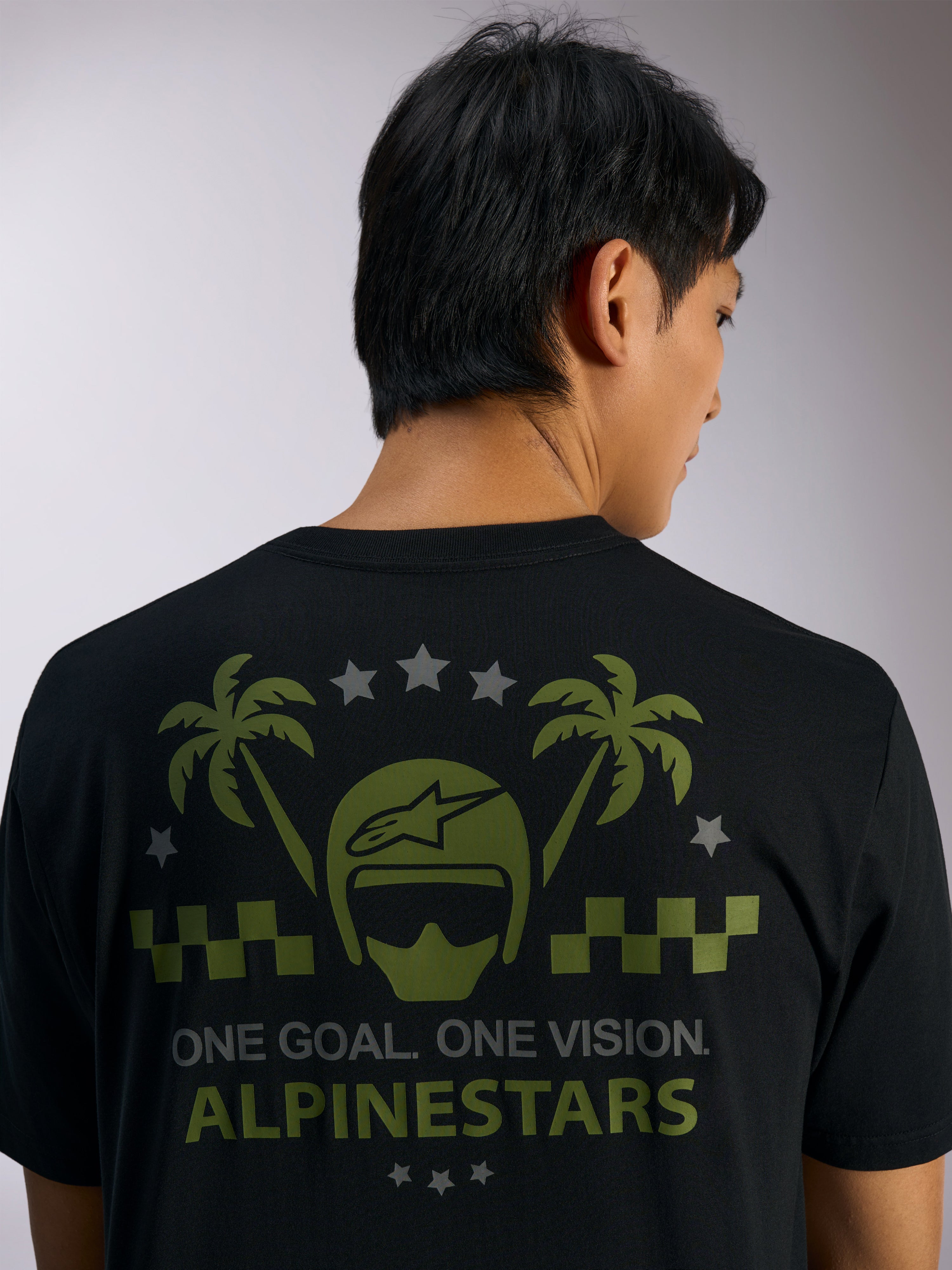 Alpinestars Order CSF Tee, t-shirt a maniche corte, nera, vista posteriore con grafiche verdi di casco e palme, stelle grigie e scritta 'ONE GOAL. ONE VISION. ALPINESTARS', streetwear casual motorsport