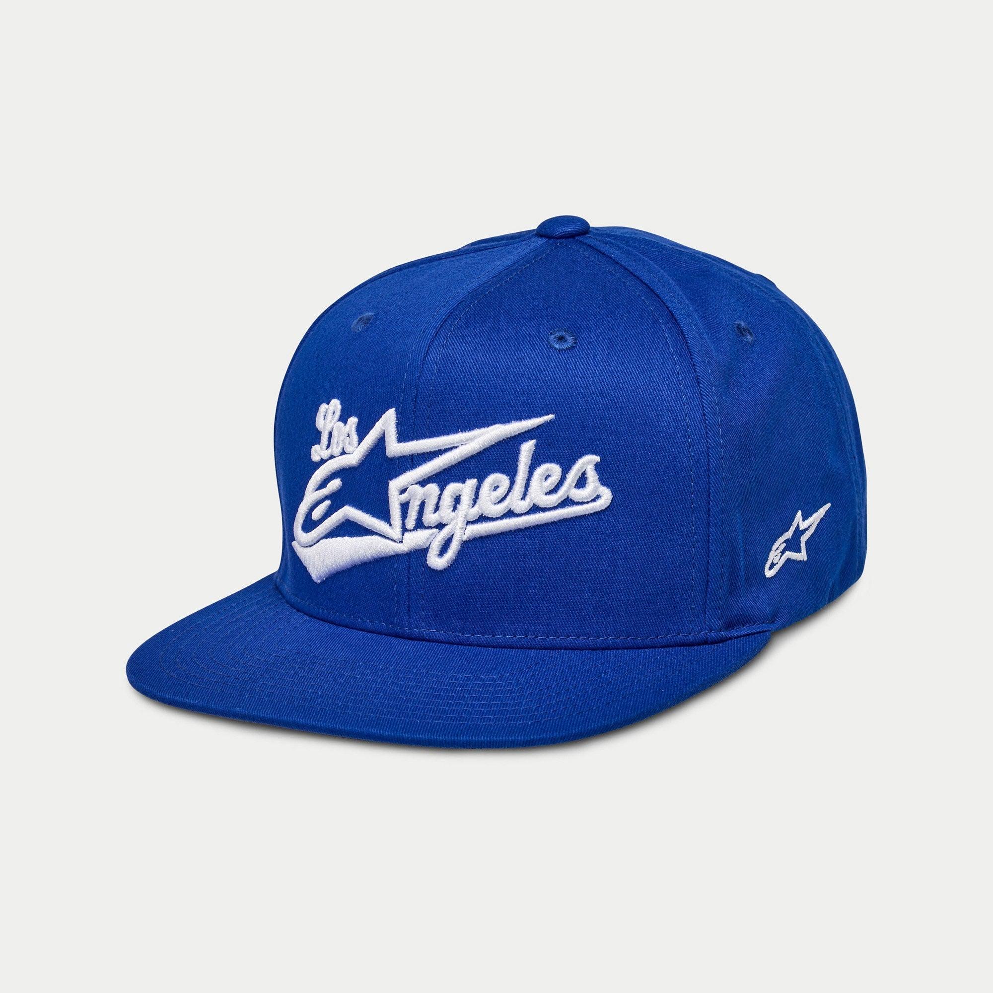 Cappello Alpinestars Los Angeles, cappellino snapback con visiera piatta, blu con ricamo 3D "Los Angeles" bianco in carattere sportivo, logo Ageless laterale, corona strutturata, copricapo casual ispirato al motorsport