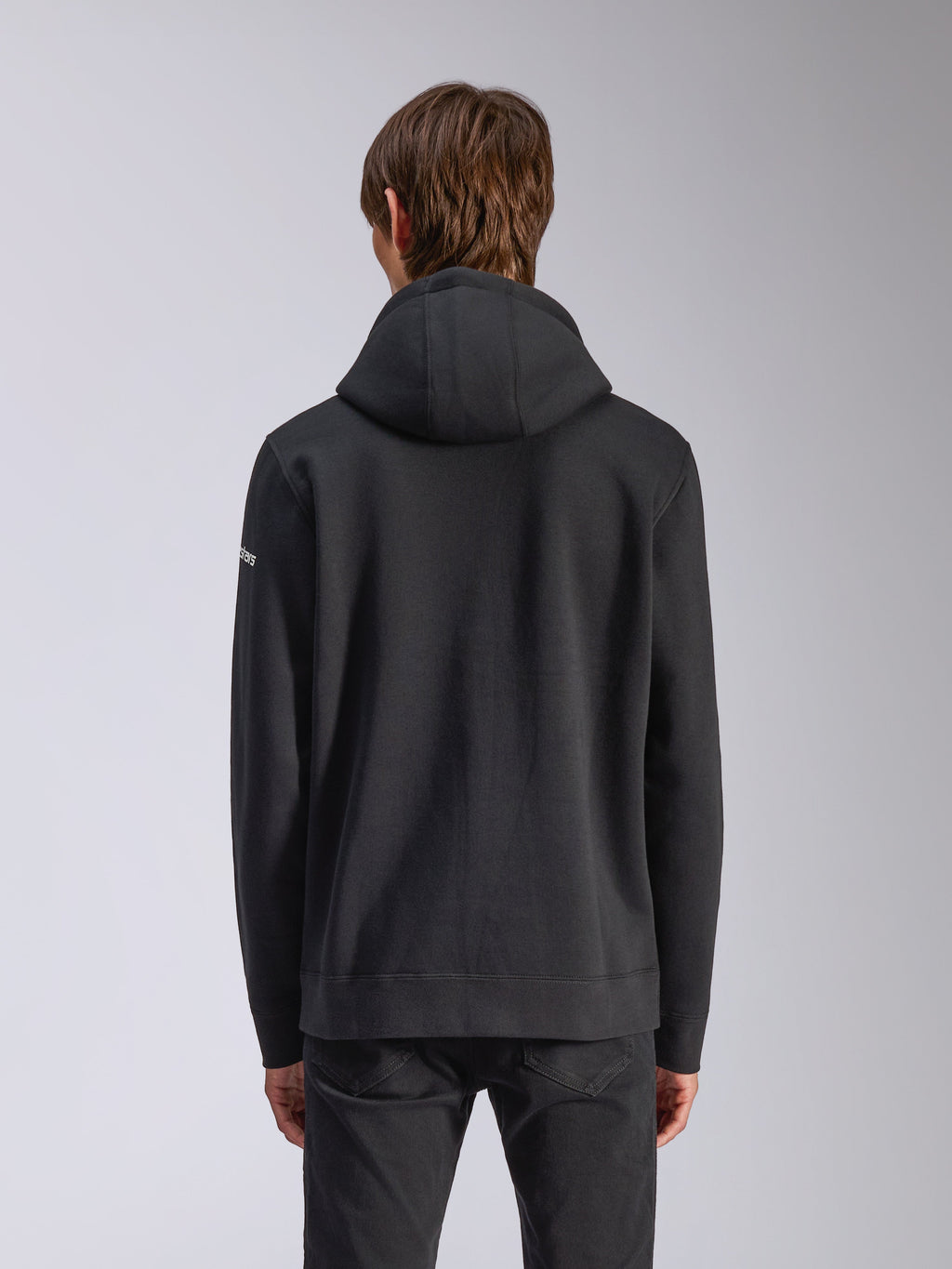 Alpinestars Felpa con cappuccio Frontal, nero, vista posteriore di una felpa casual, con cappuccio foderato, orlo a coste e logo bianco sulla manica, abbigliamento streetwear ispirato al motorsport