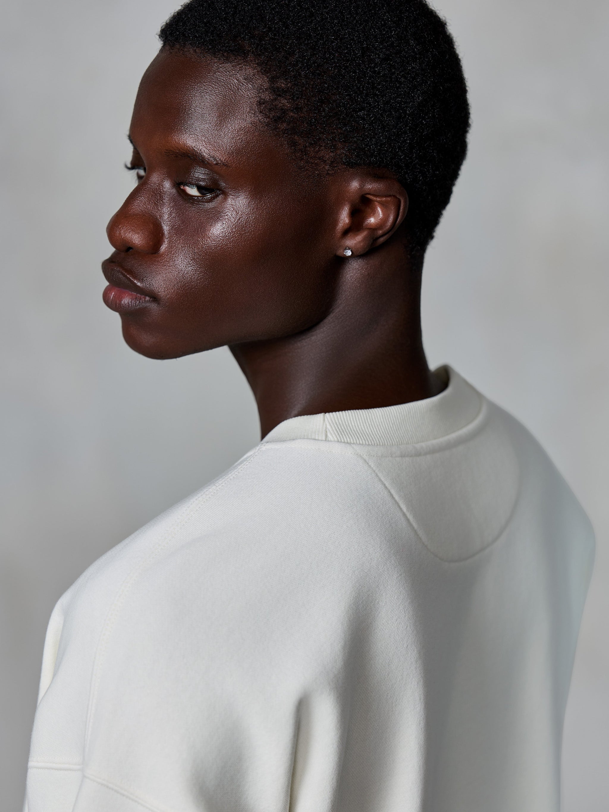 Alpinestars Essentials Ageless Crew, felpa girocollo, Off White, vista ravvicinata posteriore su modello che mostra il girocollo a costine e la trama del pile premium, streetwear lifestyle casual