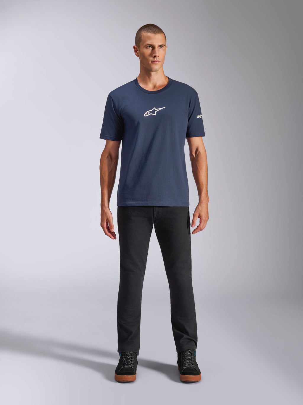 Alpinestars Frontal CSF Tee, t-shirt a maniche corte, blu navy, logo Alpinestars a stella bianco sul petto, indossata con pantaloni neri e sneakers, abbigliamento sportivo casual ad alte prestazioni