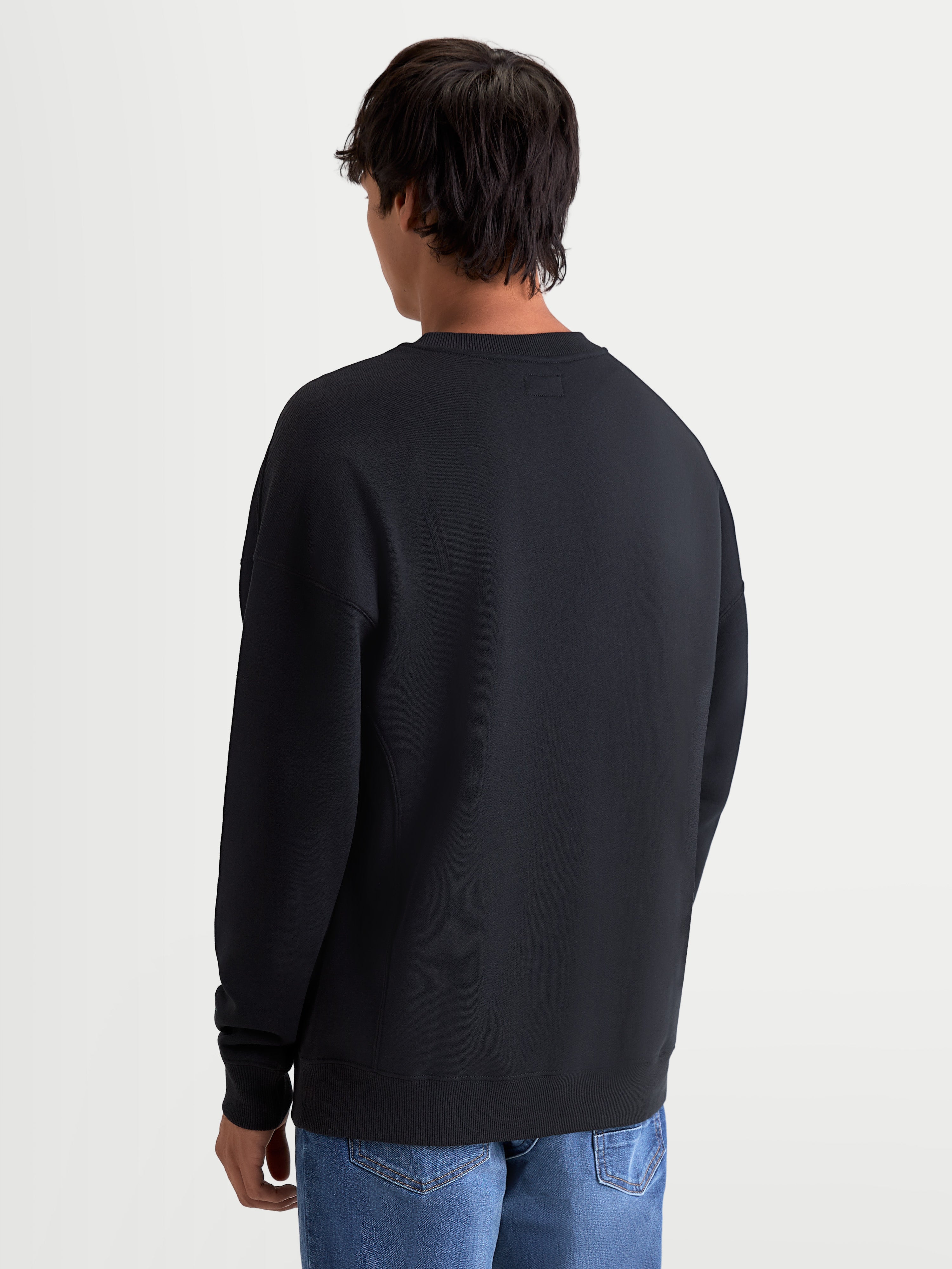 Alpinestars Guise Oversized Crew, felpa girocollo pullover sportswear da uomo, nera, in pile di cotone e poliestere riciclato, vista posteriore con vestibilità rilassata oversize e orlo a costine