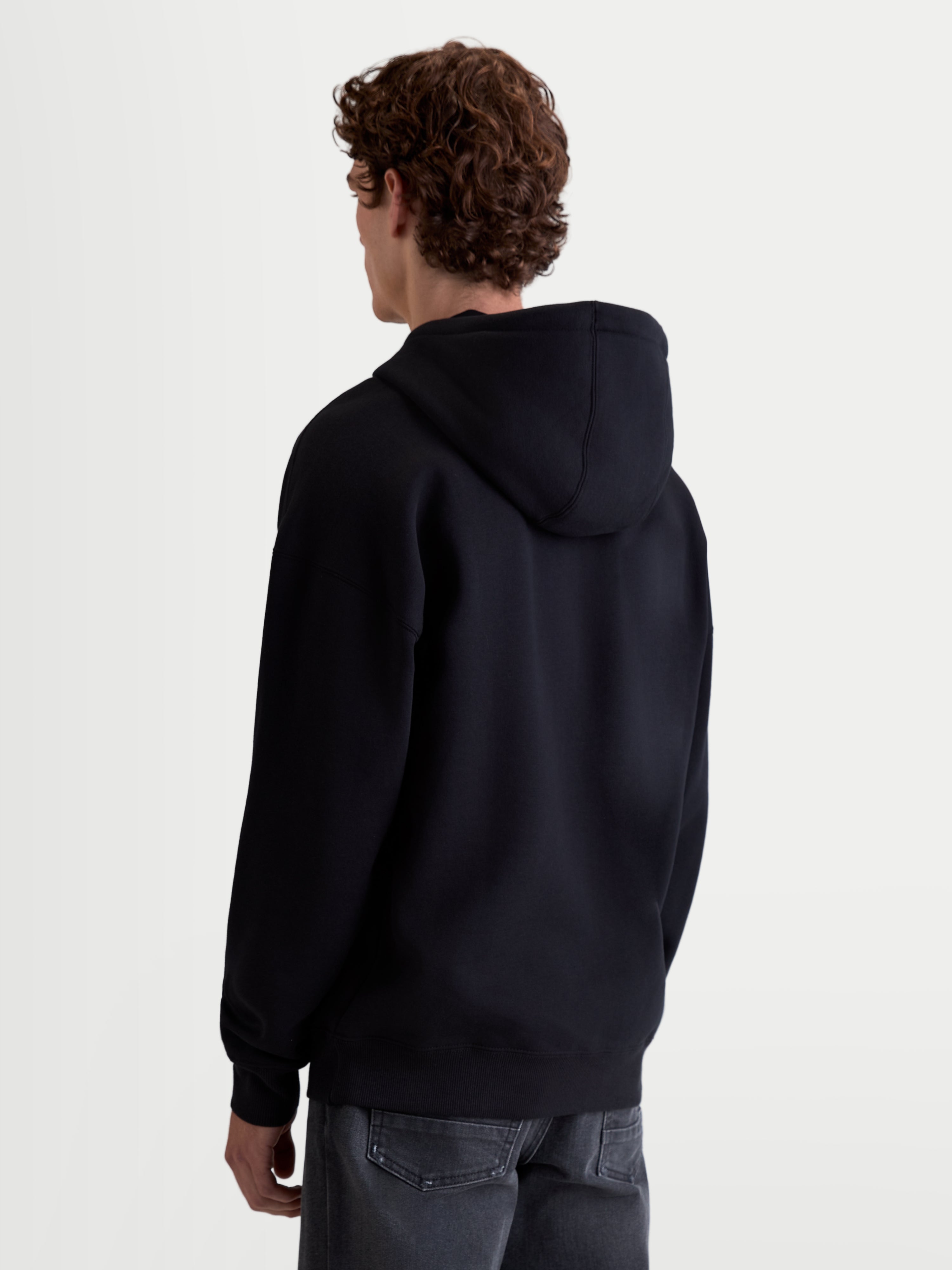 Alpinestars Felpa Con Cappuccio Prelude Oversized, felpa sportswear unisex in pile, nera, vista posteriore con silhouette rilassata, cappuccio foderato e finiture a costine su orlo e polsini.