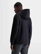 Alpinestars Felpa con cappuccio Entity Oversized, felpa in pile sportswear da uomo, nera, vestibilità oversized, vista posteriore su modello, cappuccio autofoderato e bordi a costine, misto cotone premium e poliestere riciclato