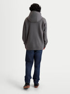 Alpinestars Felpa Con Cappuccio Entity Oversized, felpa con cappuccio unisex grigio antracite, vista posteriore su modello con vestibilità rilassata, cappuccio foderato e polsini a costine, misto cotone e poliestere riciclato, sportswear casual.