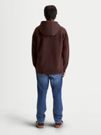 Alpinestars Felpa con cappuccio Entity Oversized, felpa marrone casual sportswear vista dal retro su modello, vestibilità rilassata oversize, realizzata in pile di misto cotone riciclato, abbigliamento lifestyle.