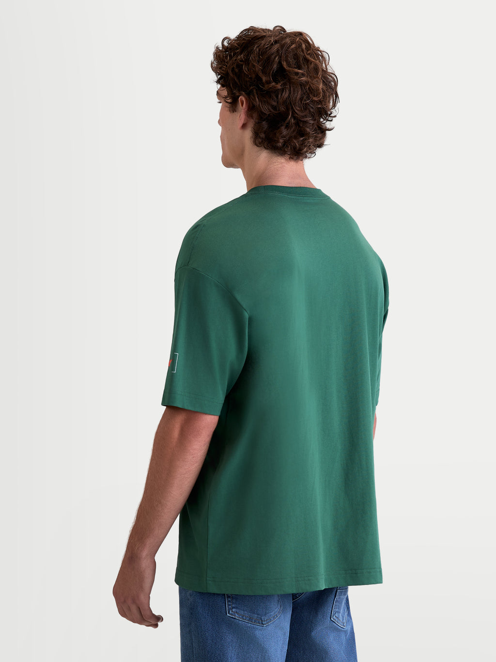 Alpinestars Maglietta Infinity Oversized CSF, maglietta sportswear da uomo a maniche corte, verde, vestibilità oversized, vista posteriore su modello con dettaglio del logo sulla manica