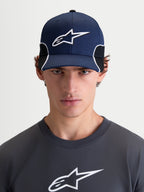 Alpinestars Cappello 500 Snapback, cappello da baseball sportswear da uomo, blu navy e nero, con visiera curva, corona strutturata, logo Astars ricamato in 3D e piping bianco a contrasto, vista frontale su modello.