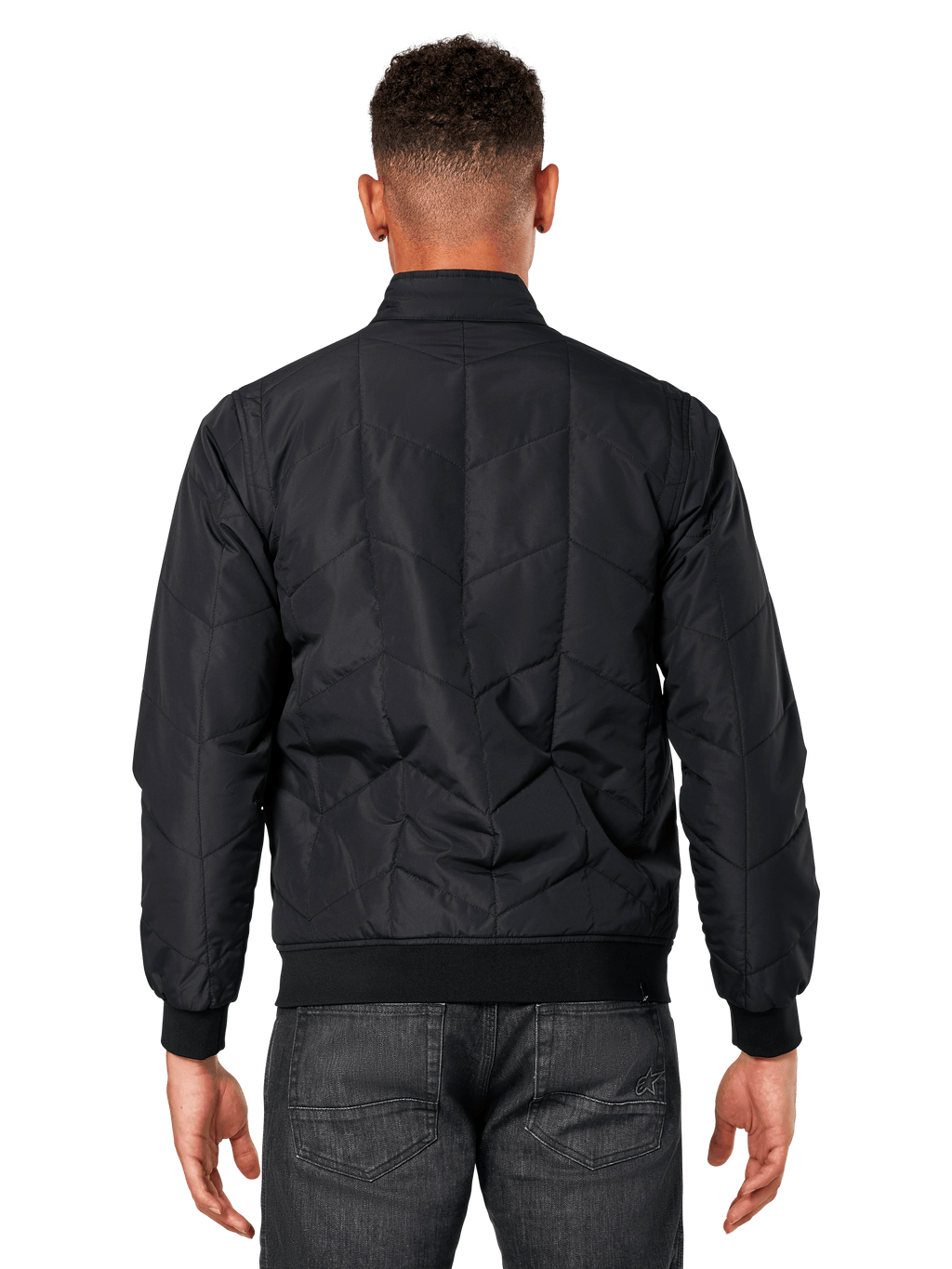 Giacca Alpinestars Precedent, nero, vista posteriore su modello, con iconico motivo trapuntato angolato, polsini e orlo a coste, design motorsport trapuntato ispirato alla F1