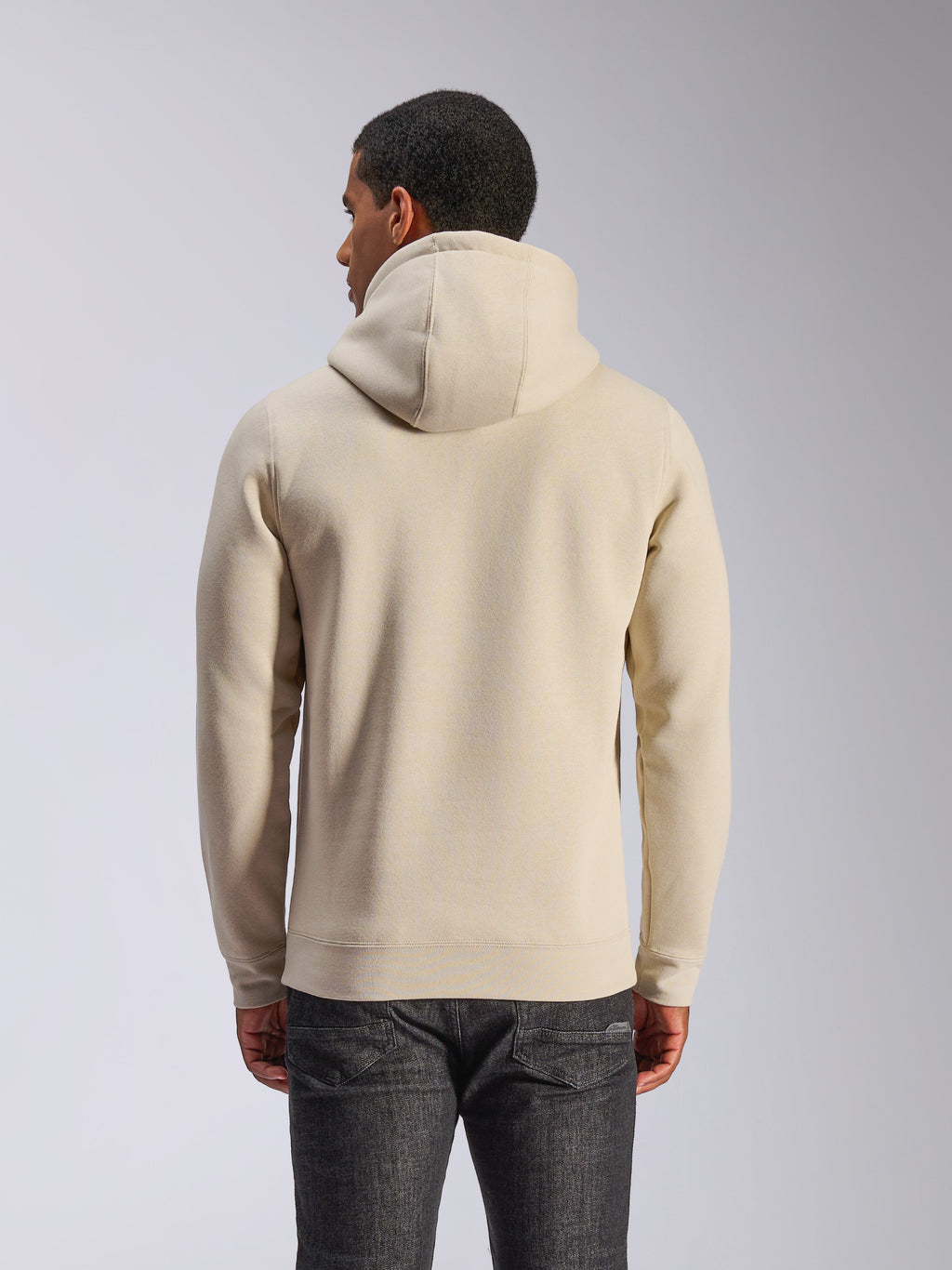Alpinestars Ageless V3 Hoodie, bianco sporco, vista posteriore, abbigliamento sportivo casual, con cappuccio foderato in jersey, maniche lunghe con polsini e orlo a costine, indossata con jeans in denim scuro