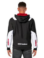 Alpinestars Sessions V3 Hoodie, vista posteriore, nero con pannelli bianchi sulle maniche e interno del cappuccio rosso, con scritta bianca sul retro e logo rosso sulle maniche, streetwear casual ispirato al motorsport