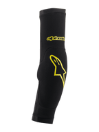 Alpinestars Paragon Plus, gomitiere protettive, nero e giallo acido, design a calza con imbottitura integrata, con logo a stella e scritta gialli, rete traspirante per protezione MTB