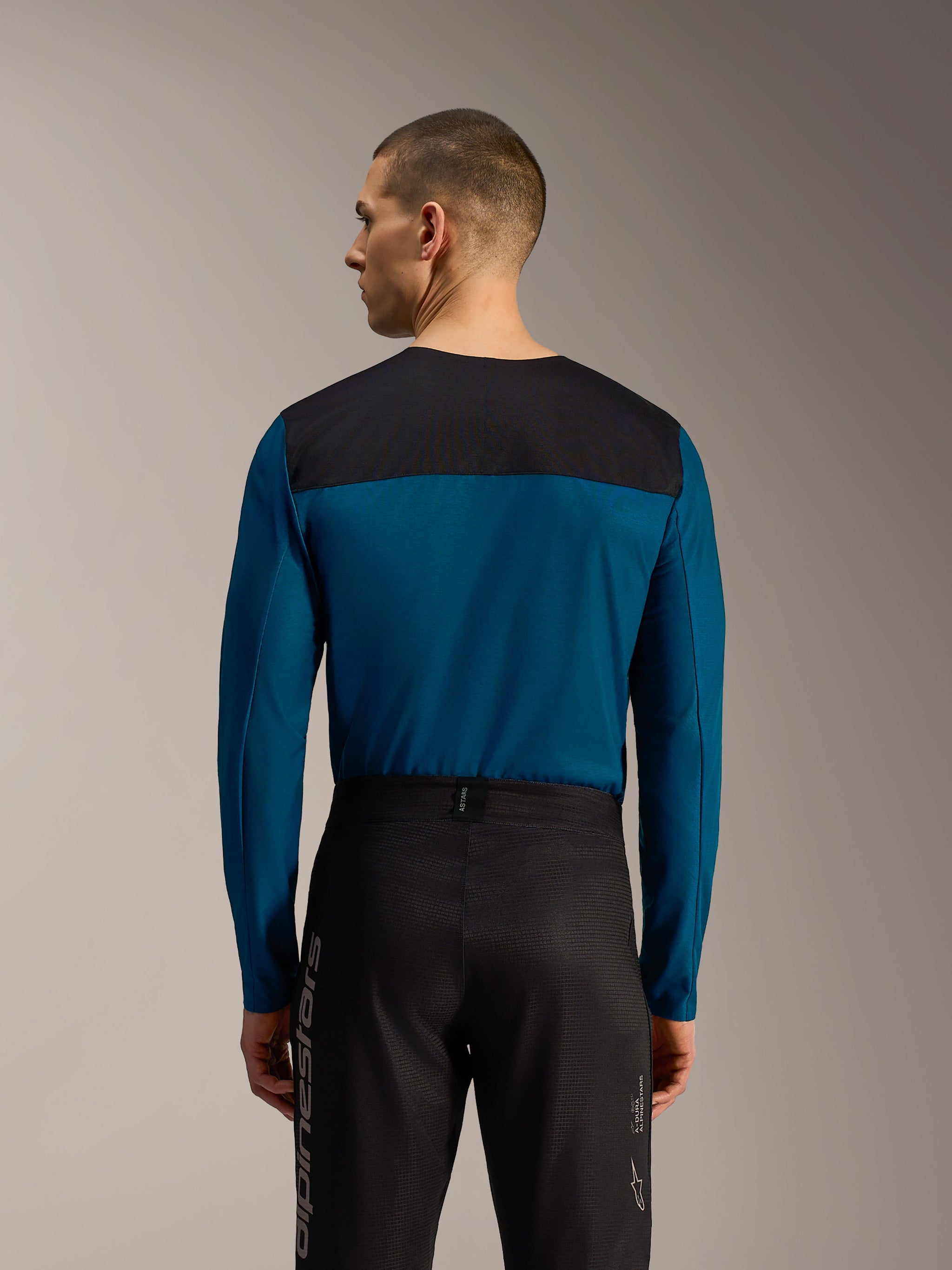 Pantaloni A-Dura Elite Flex neri, vista posteriore con tessuto ripstop resistente e logo Alpinestars verticale per MTB.