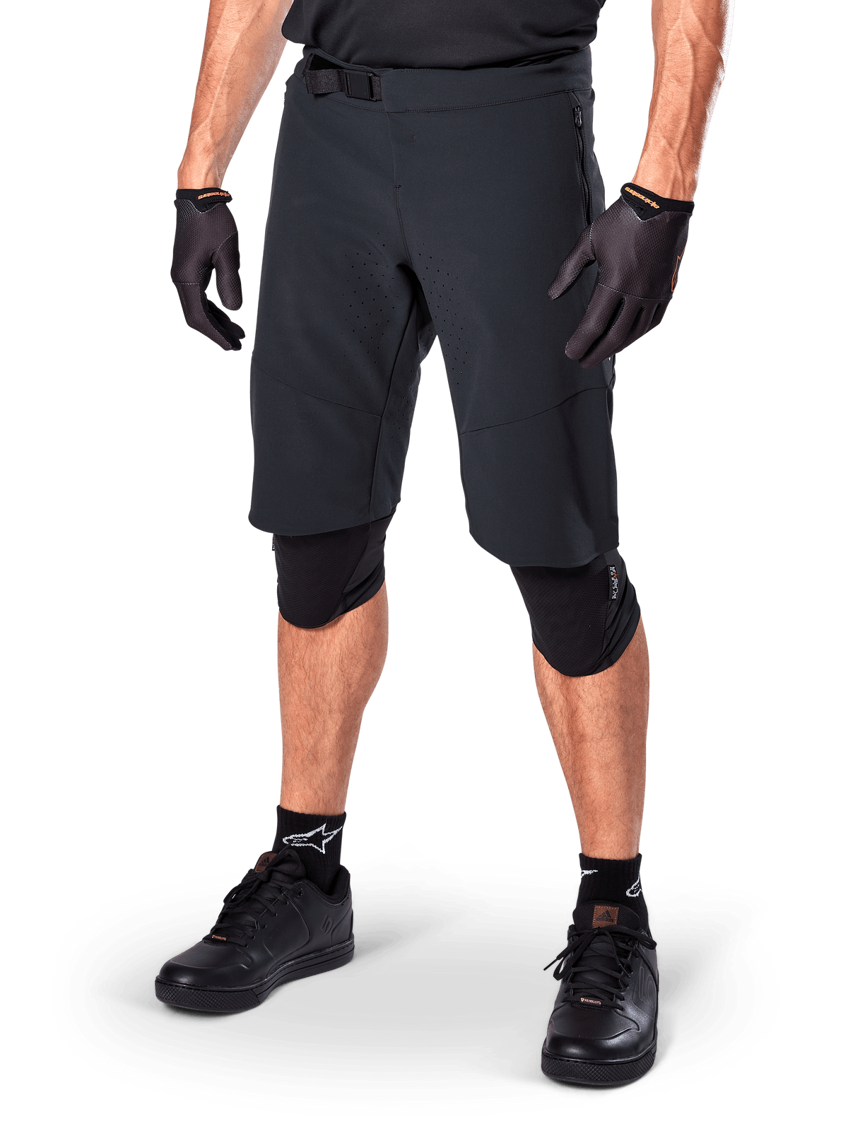 Alpinestars Pantaloncini A-Aria Elite, pantaloncini da ciclismo neri, indossati con guanti e ginocchiere neri coordinati, dotati di fibbia magnetica e perforazioni tagliate al laser, design essenziale per mountain bike fuoristrada