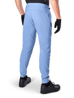 Pantaloni Alpinestars A-Dura, pantaloni da mountain bike, Infinity Blue, vista posteriore che mostra la vestibilità regolare e i polsini elasticizzati, indossati con guanti neri e calzature nere, abbigliamento da ciclismo resistente in tessuto elasticizzato bidirezionale.