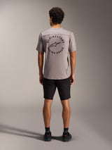 Maglia A-Dura Air grigia con grafica circolare Alpinestars Racing Ahead sul retro e pantaloncini MTB neri.