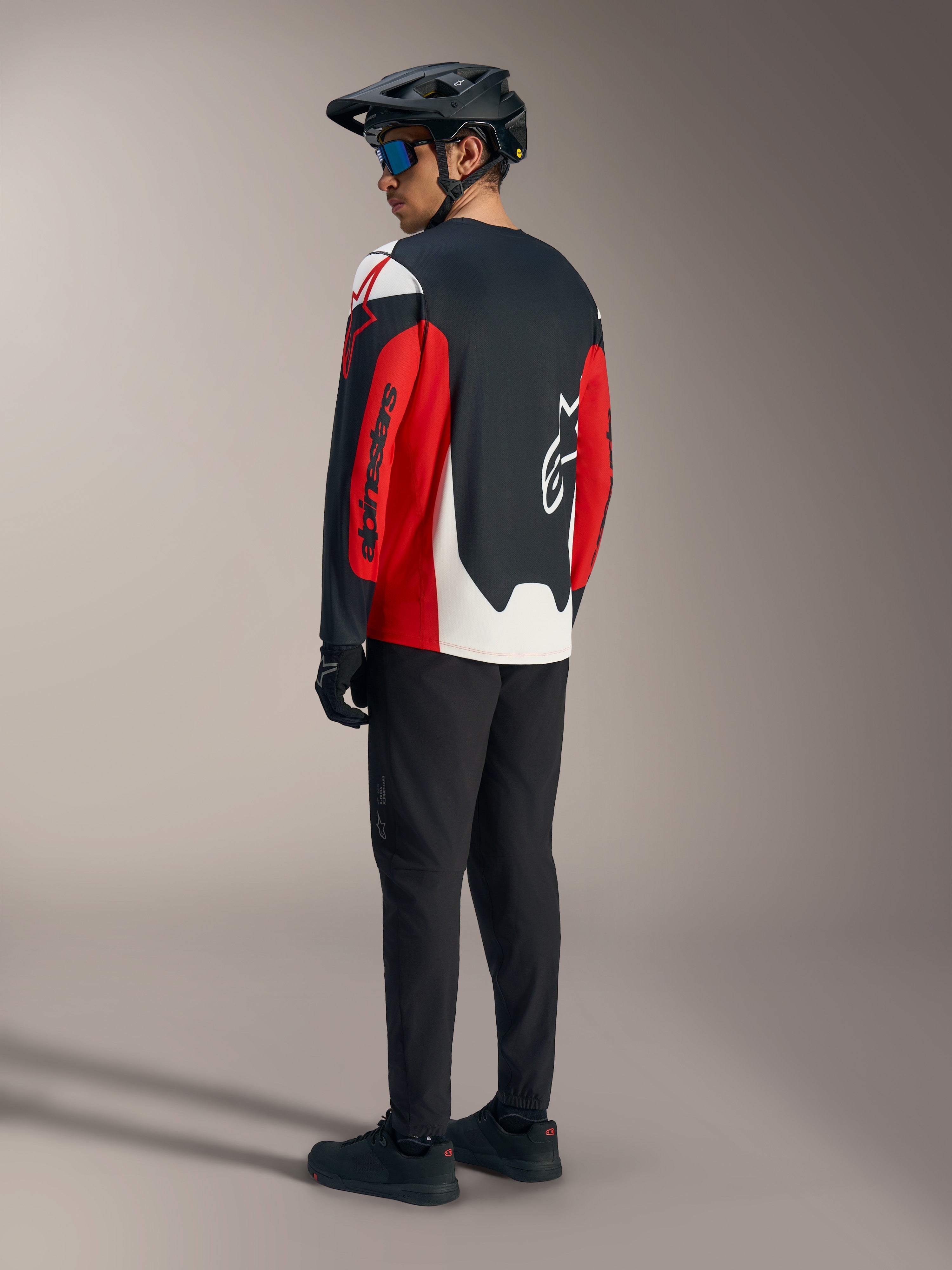 Maglia Alpinestars A-Dura Race rossa a maniche lunghe, vista posteriore con grafiche audaci, kit tecnico mountain bike.