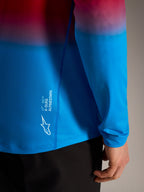 Maglia MTB A-Dura ASTARS 2.0 a maniche lunghe con sfumatura rosso e blu e logo Alpinestars bianco sul lato.