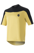 Alpinestars Drop Meta Jersey - manica corta, maglia da ciclismo MTB, oro e nero, costruzione in rete con spalle a contrasto, logo circolare sul petto e bordo posteriore allungato.