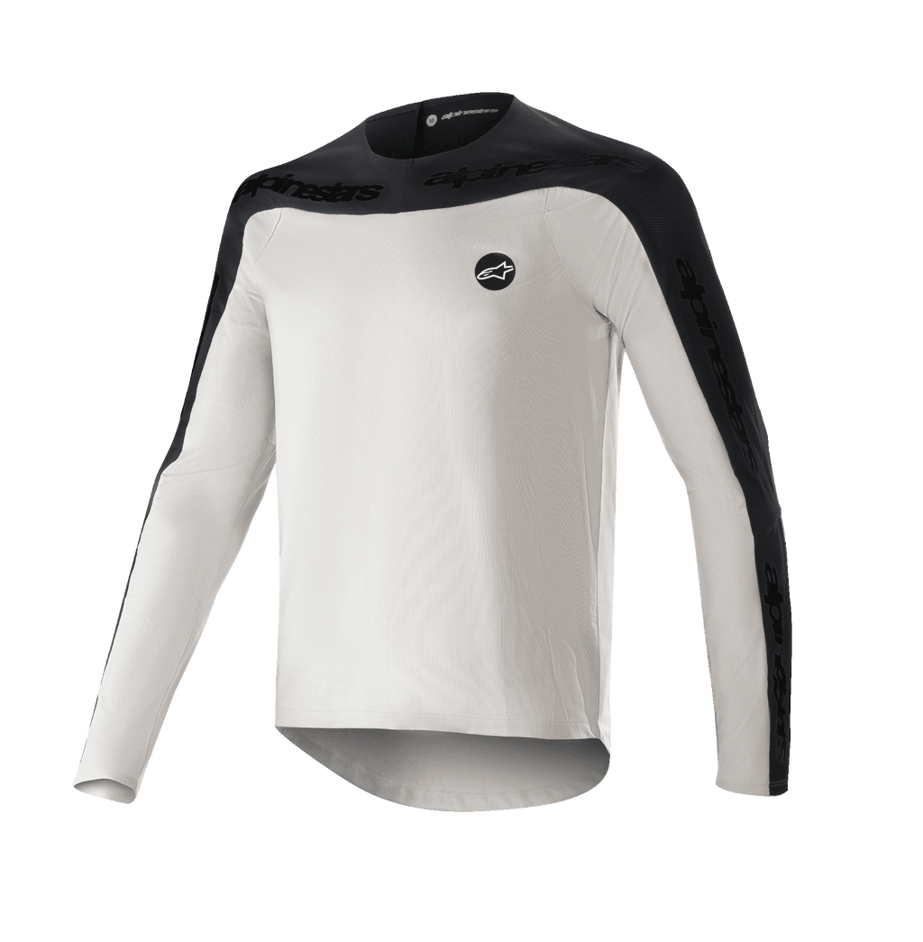 Alpinestars Drop Meta Jersey a manica lunga, maglia da mountain bike MTB, grigio chiaro e nero, con sprone sulle spalle e pannelli esterni delle maniche neri con marchio testuale, orlo posteriore allungato per una maggiore copertura e logo circolare sul petto a sinistra