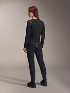 Alpinestars Stella A-Dura Thermal Jersey da donna, maglia da MTB a maniche lunghe in nero, vista posteriore con dettagli riflettenti sulle spalle e coda allungata, indossata con pantaloni e scarpe neri, abbigliamento tecnico per mountain bike