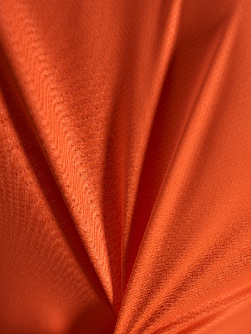 Dettaglio del tessuto jacquard arancione della maglia Alpinestars Stella A-Dura Ride, trama leggera ed elastica.