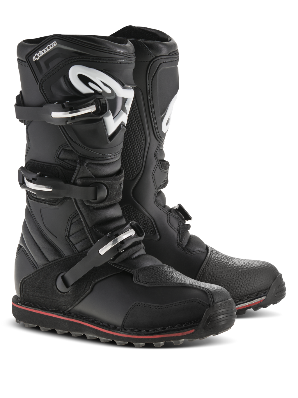 Alpinestars Tech-T Boots, stivali da moto da trial, nero con accenti rossi e bianchi, sistema di chiusura a tre fibbie, placca tibiale ergonomica con logo Astars bianco, sottile striscia rossa lungo la suola, robusta struttura in pelle per il trial e la guida fuoristrada