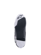 Stivali Alpinestars Tech 10 Supervented, stivali da motocross, vista della suola, trama grip a nido d'ape nera su base bianca e nera, inserto centrale sostituibile, con il logo Alpinestars sulla punta