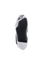 Suola degli stivali Alpinestars Tech 10 Supervented, vista dal basso con design a doppia mescola bianco e nero, trama grip a nido d'ape, inserto centrale sostituibile e logo Alpinestars in rilievo, ottimizzata per le prestazioni sulle pedane da motocross