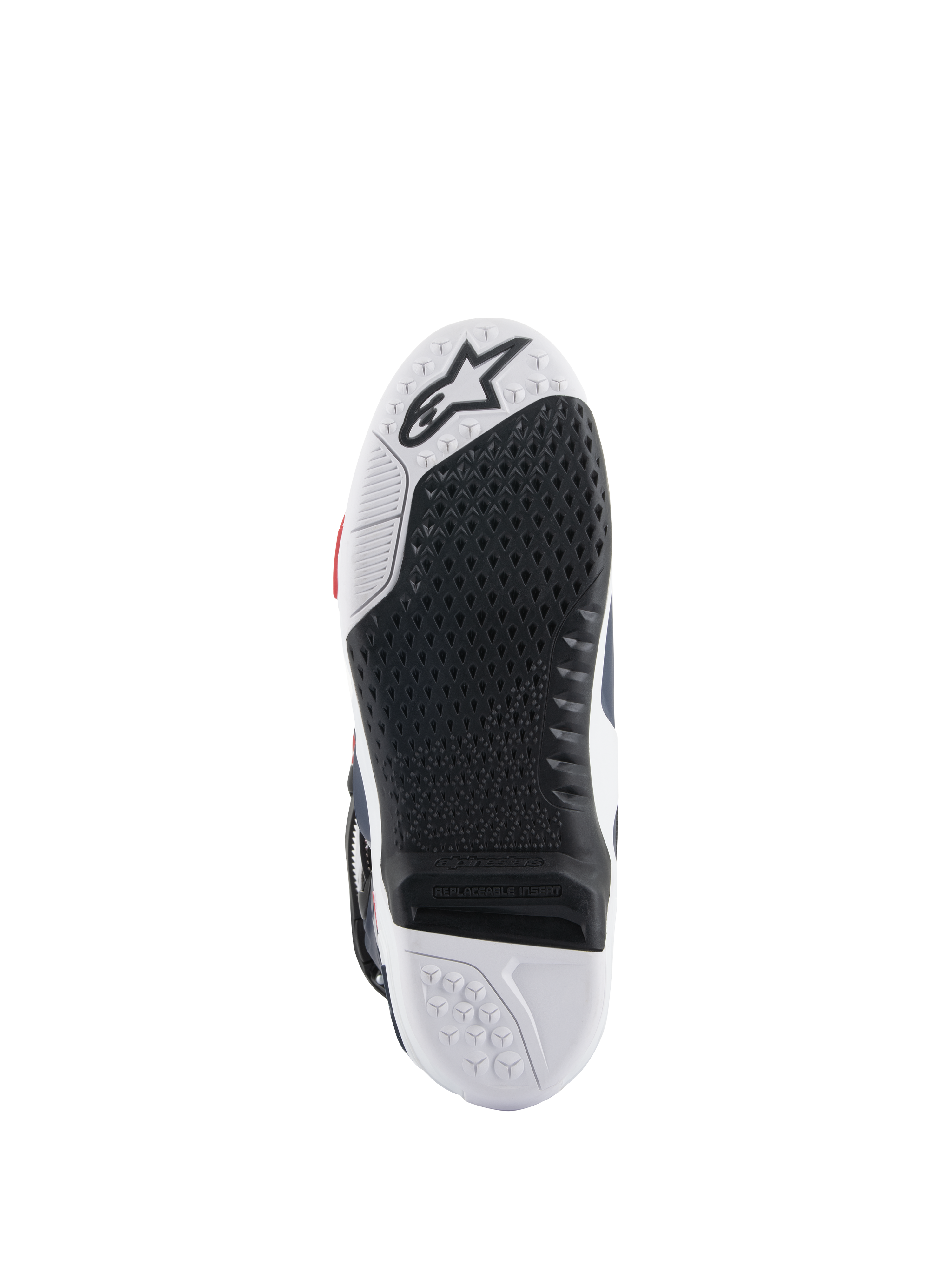 Suola degli stivali Alpinestars Tech 10 Supervented, vista dal basso con design a doppia mescola bianco e nero, trama grip a nido d'ape, inserto centrale sostituibile e logo Alpinestars in rilievo, ottimizzata per le prestazioni sulle pedane da motocross