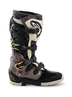 Stivali Alpinestars 2026 Tech 7 Enduro Drystar®, stivali da motocross ed enduro, nero, grigio scuro e oro, caratterizzati da un sistema di chiusura multi-fibbia con accenti dorati, suola robusta a doppia mescola e pannelli protettivi in TPU resistente, calzature professionali per la guida fuoristrada