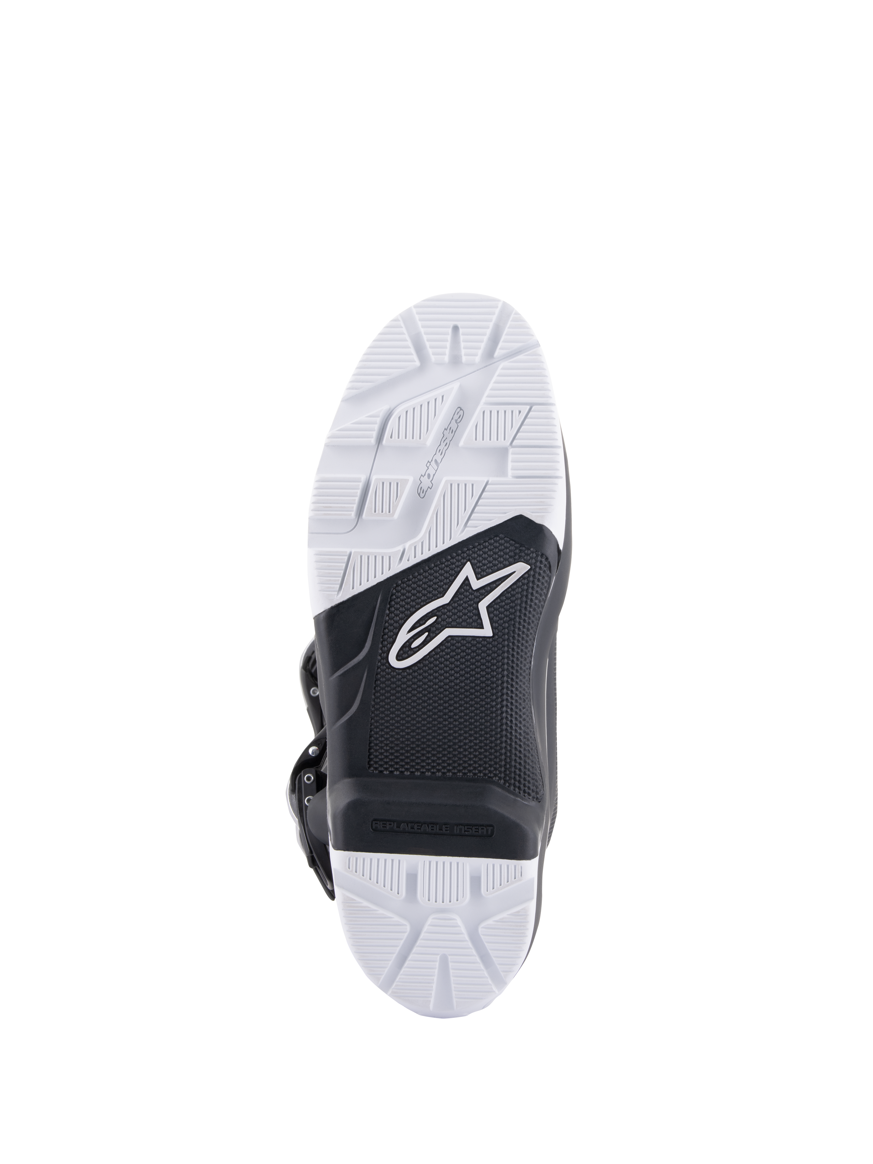 Stivali Alpinestars Tech 7 Enduro, vista della suola che mostra la suola in mescola specificamente progettata, design bicolore bianco e nero con motivi di grip strutturati, con logo a stella bianco e inserto per pedana sostituibile.