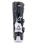 Stivali Alpinestars Tech 7 Enduro Drystar, nero e bianco, vista posteriore che mostra la struttura protettiva in TPU, zone di flessione a fisarmonica bianche e sistema di chiusura con fibbie, con marchio Alpinestars sul tallone e sulla tomaia