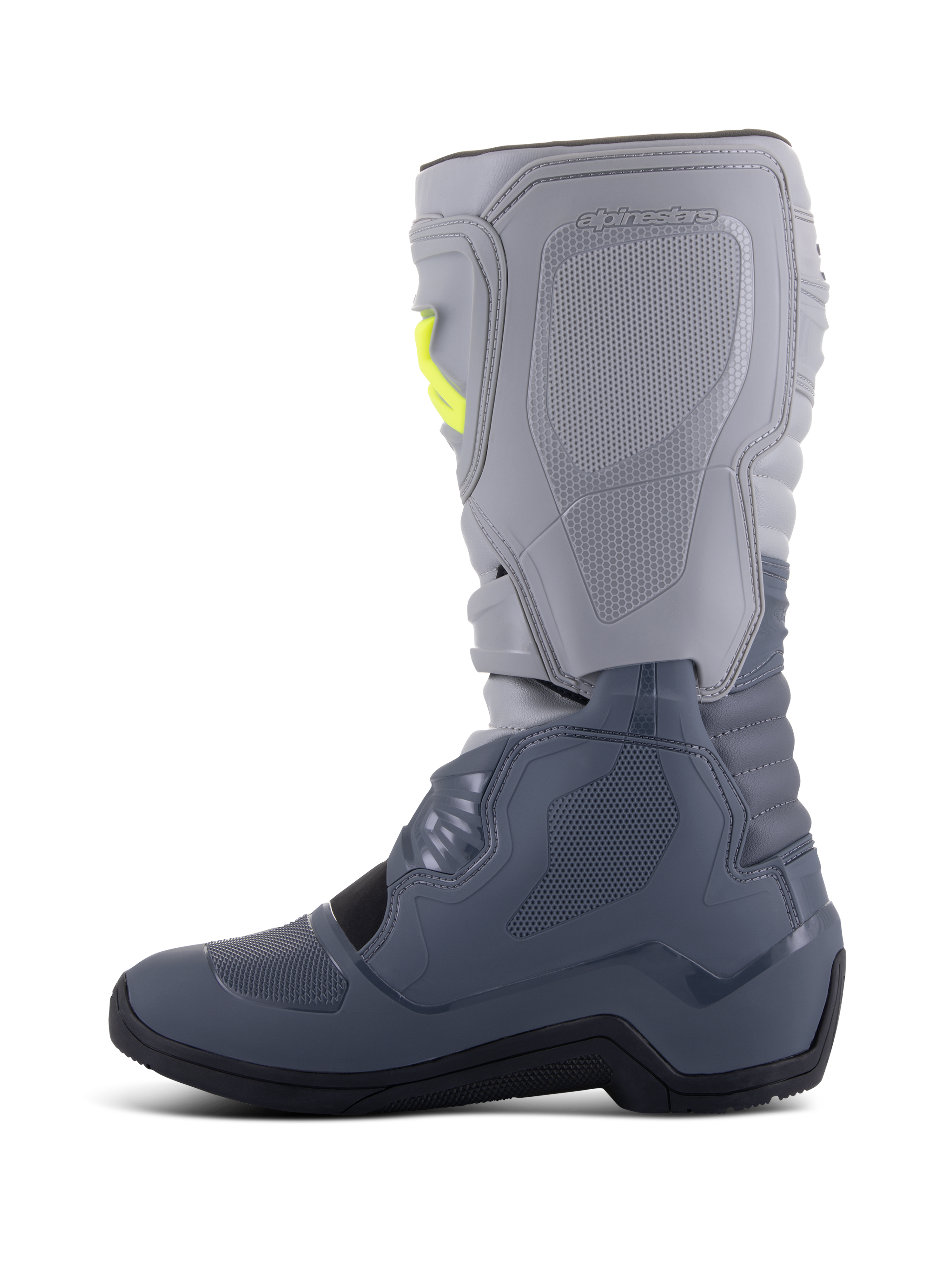 Stivali Alpinestars Tech 3, stivali da motocross, grigio scuro, grigio chiaro e nero, vista laterale con parte superiore grigio chiaro e sezioni inferiori grigio scuro, accenti gialli sulle fibbie, piastre protettive in TPU e suola nera resistente.