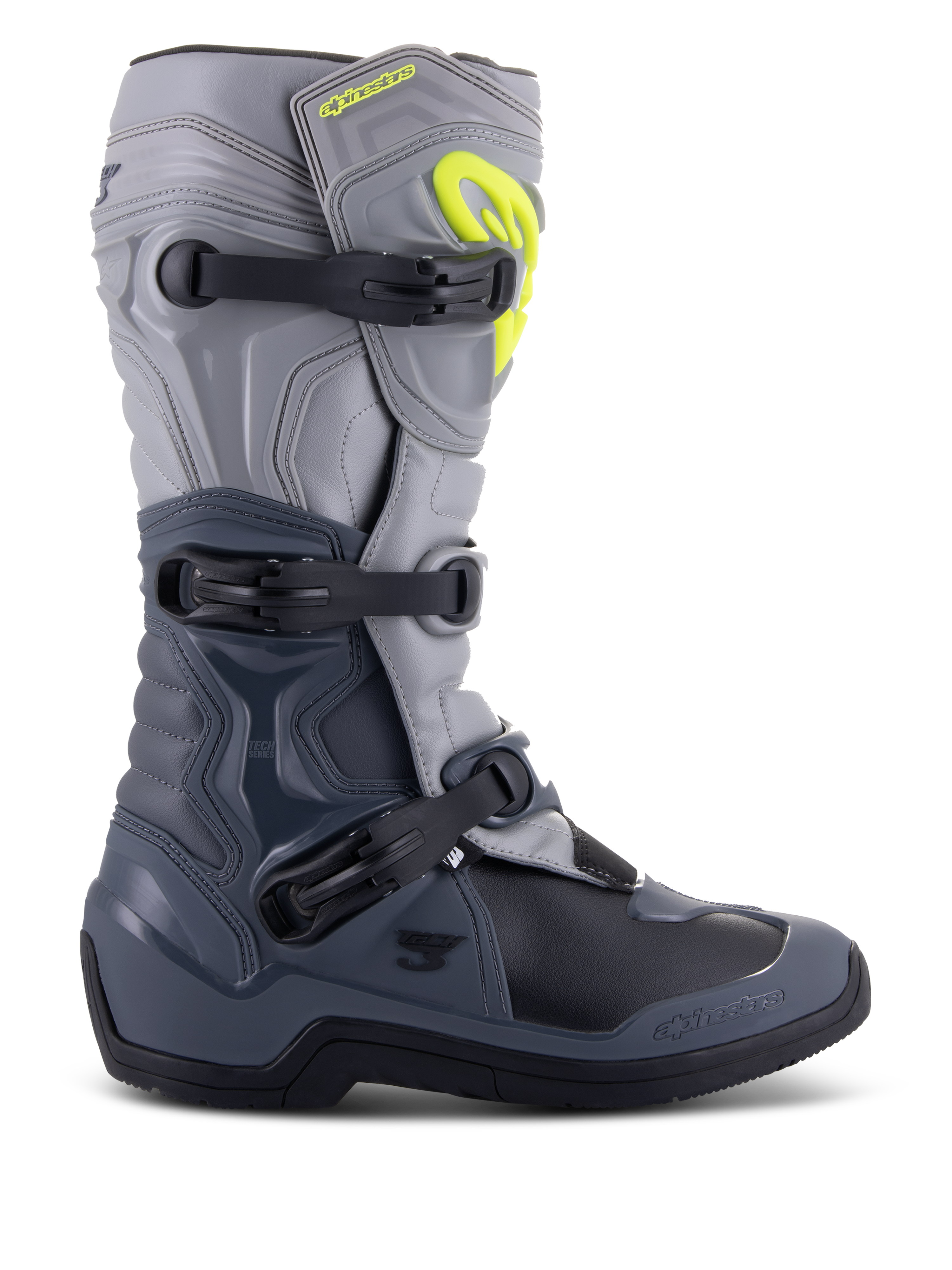 Stivali Alpinestars Tech 3, stivali da motocross, grigio scuro, grigio chiaro e nero, vista laterale con tre fibbie in polimero nero, pannelli di protezione in TPU e logo Alpinestars giallo brillante sulla parte superiore dello stinco