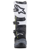 Stivali Alpinestars Tech 5, stivali da motocross, nero, grigio scuro e bianco, vista frontale con sistema di chiusura multi-fibbia, pannello superiore bianco con logo Astars nero, punta rinforzata grigio scuro e discreti accenti gialli