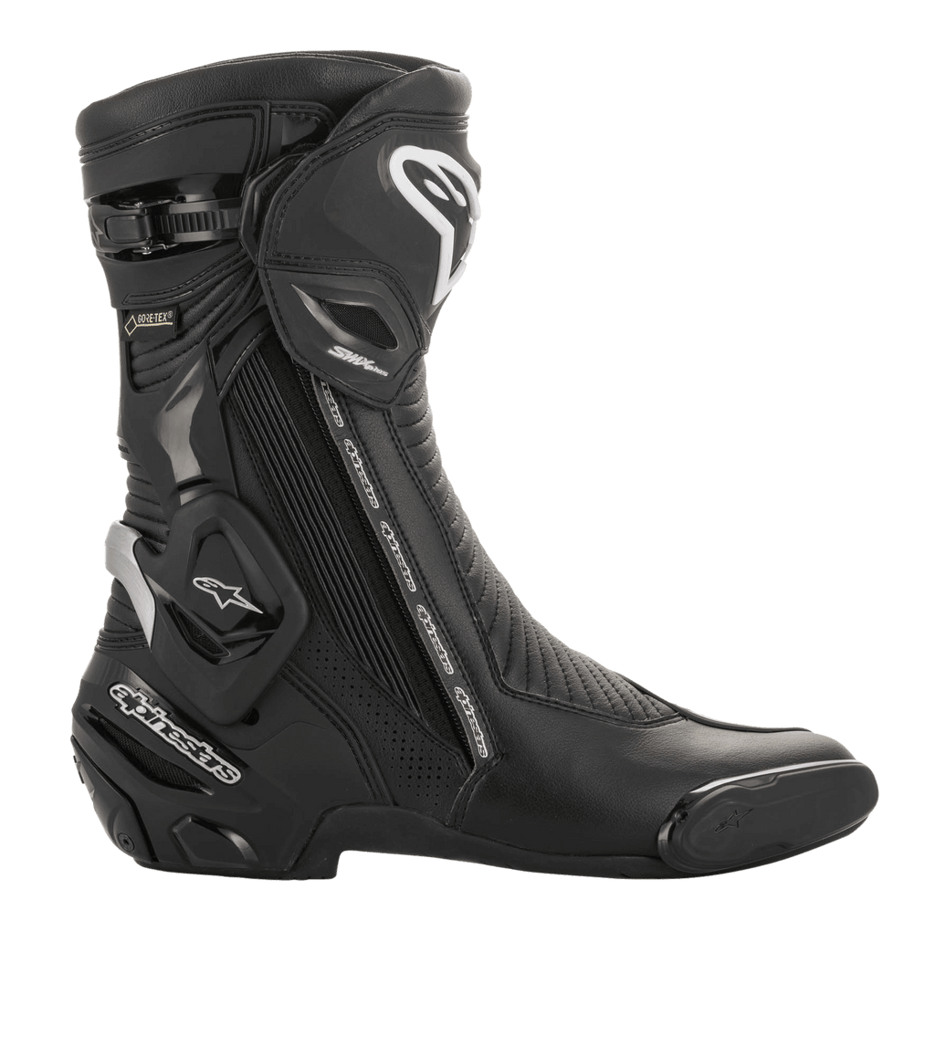 Stivale Alpinestars SMX Plus V2 GORE-TEX, calzatura sportiva da moto, nero e argento, vista laterale con logo Alpinestars bianco, placca parastinchi protettiva e marchio GORE-TEX, progettato per corse ad alte prestazioni e guida su strada