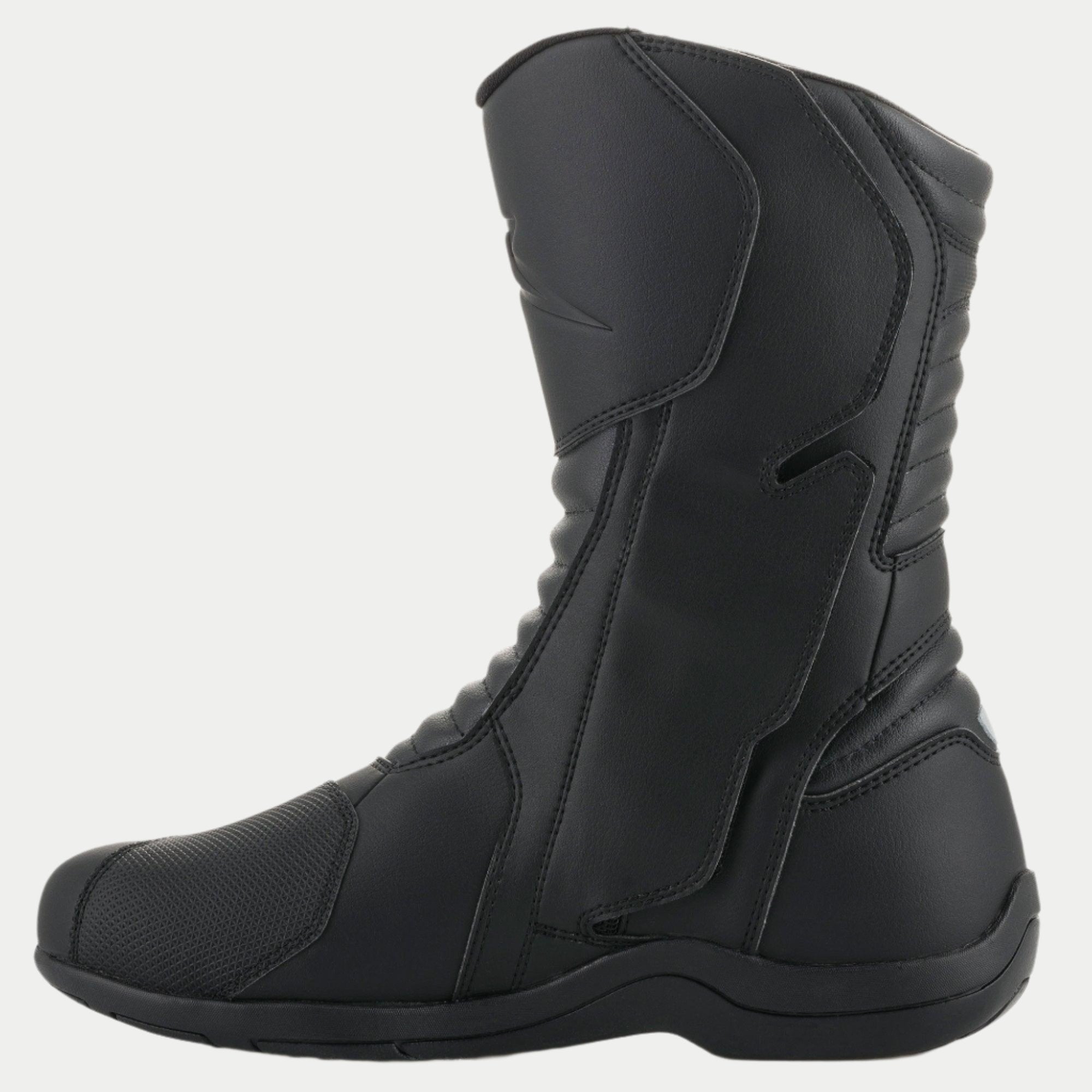 Stivali Alpinestars Origin Drystar®, stivali da moto touring neri, vista laterale del lato mediale che mostra l'aletta del sistema di ingresso, tomaia in microfibra con zone a soffietto anteriori e posteriori, design impermeabile per guida su strada e adventure