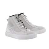 The Stella Stated Podium Shoes by Alpinestars EU are white high-top sneakers crafted for an urban riding environment. They feature lace-up fronts, textured sides, and slightly raised rubber soles. Designed for a women’s fit, these shoes have a subtle logo on the outer surface and appear brand new against a plain black background.