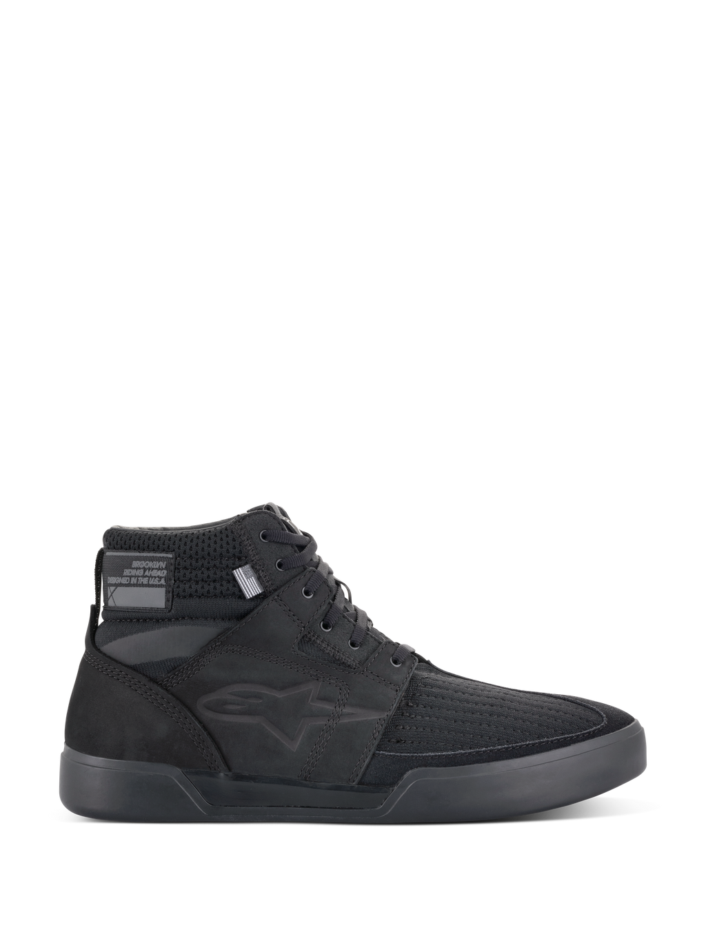 Alpinestars Primer Riding Shoes, sneaker da moto nere, calzature da guida urbana alte, vista laterale, tomaia in mesh testurizzato, suola in gomma spessa, design sportivo moderno con logo a stella discreto