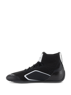 Scarpe Alpinestars Supertech, scarpe da auto racing, nero, profilo laterale con tomaia lavorata a maglia, tallone in fibra di carbonio e dettagli geometrici bianchi, calzature professionali da motorsport