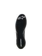 Scarpe Alpinestars Supertech K - FIA, scarpe da karting, nero, vista dal basso che mostra la suola in gomma ultra-sottile con battistrada asimmetrico, logo a stella bianco sull'avampiede e nome del brand bianco sul tallone, progettate per la massima sensibilità sui pedali.