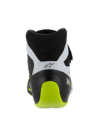 Scarpe Alpinestars Tech-1 KX V3, scarpe da kart certificate FIA, nero bianco e giallo fluo, vista posteriore che mostra il tallone rinforzato in un unico pezzo, accento giallo fluo brillante, pannelli bianchi con logo nero, calzature tecniche da motorsport per uso in pista.