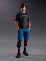 Maglia Alpinestars A-Dura Ride SS nera e pantaloncini blu, outfit completo da MTB con casco e protezioni.
