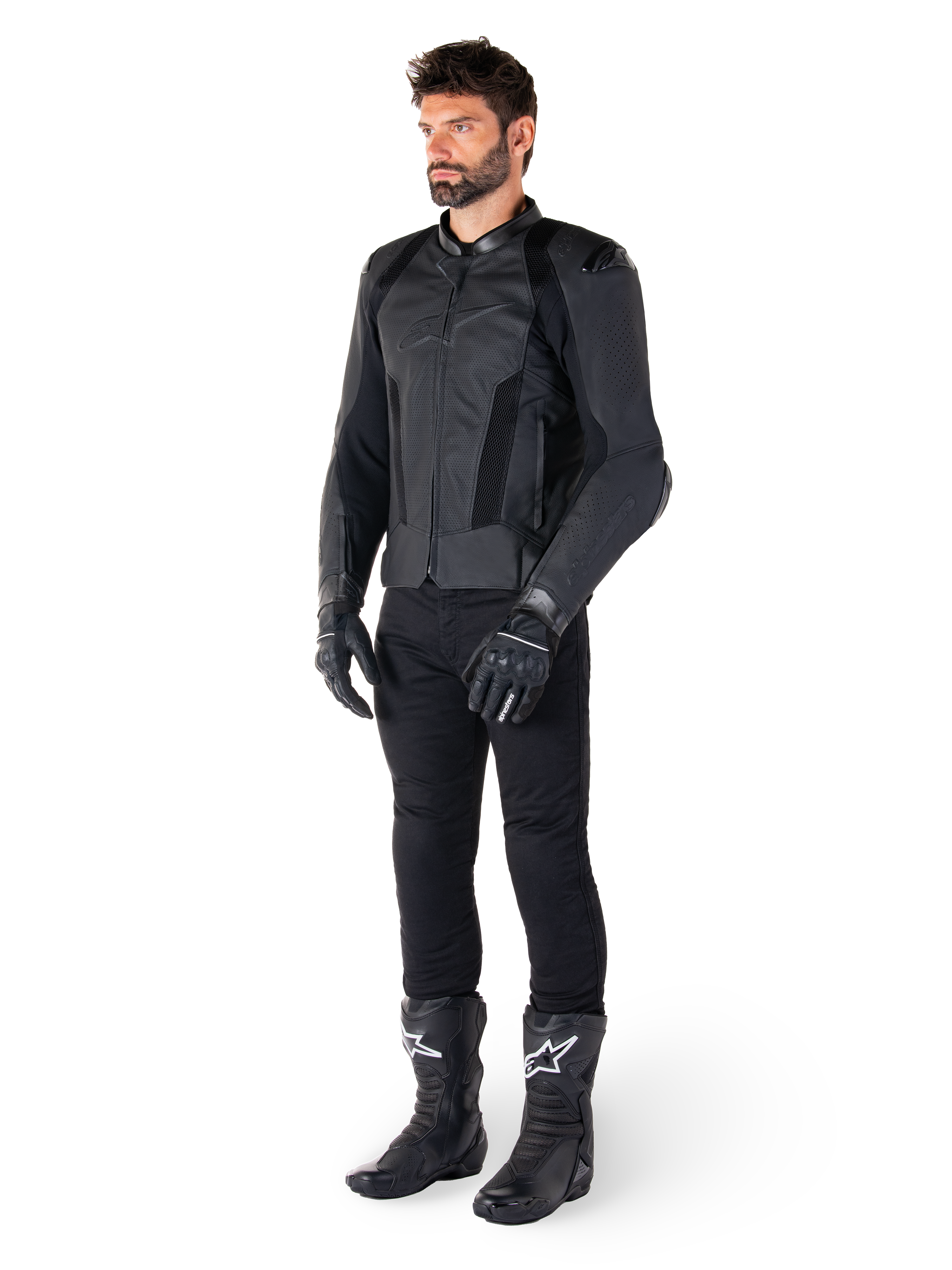 Alpinestars Missile V3 Airflow Leather Jacket, nero, indossata da un pilota con pantaloni, guanti e stivali neri coordinati, con pelle bovina traforata per la massima ventilazione e protezioni DFS sulle spalle, abbigliamento da moto sportivo premium