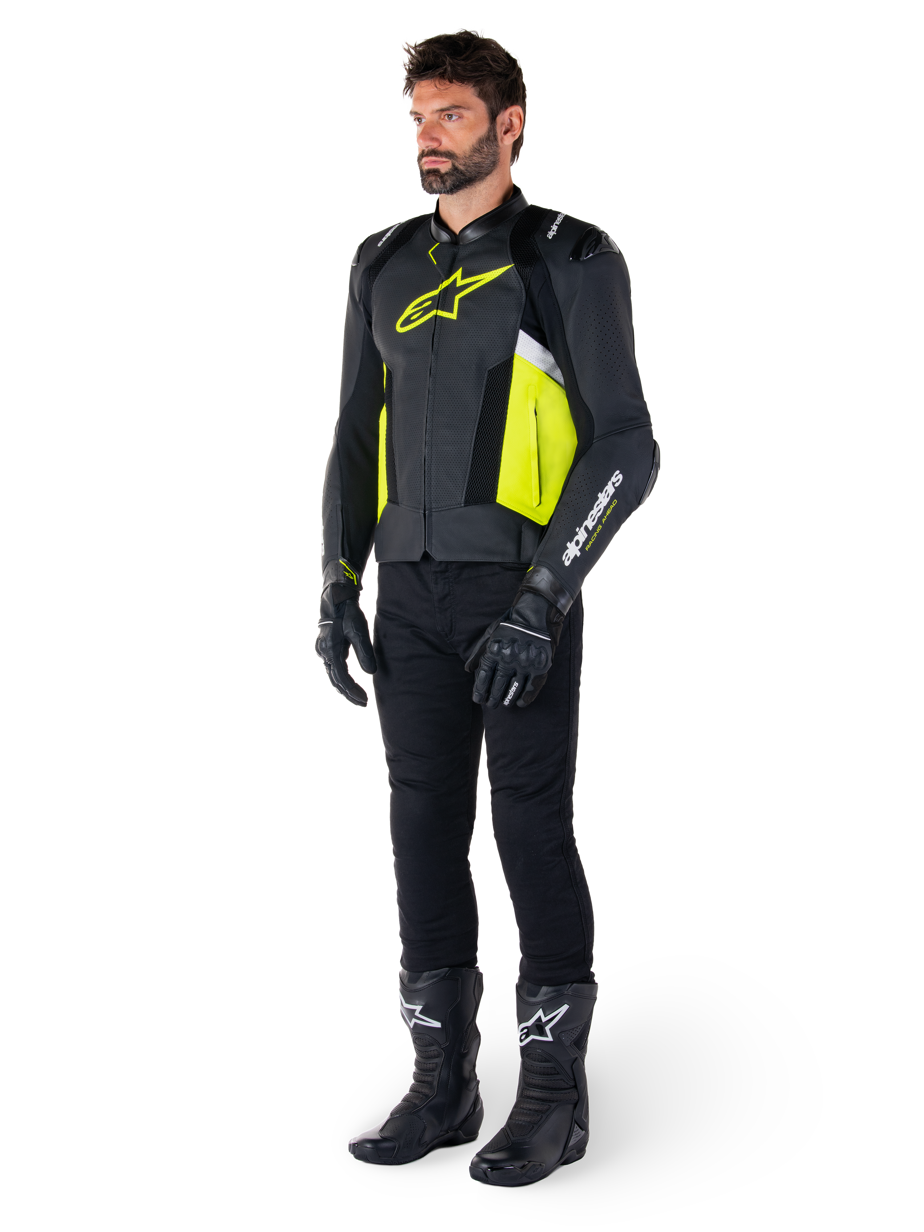 Modello uomo che indossa la giacca in pelle Alpinestars Missile V3 Airflow in nero, giallo fluo e bianco, abbinata a guanti, pantaloni e stivali da moto neri, che mette in risalto il design in pelle traforata e l'estetica ispirata alle corse.
